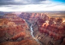 Phantom Ranch LOCKED DOWN After Sudden Deluge Grand Canyon with river winding through layered red cliffs