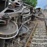 NATO Border Jolt: Drone Hits Passenger Train Overturned train cars beside railway tracks