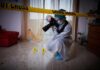 forensic photographer documenting indoor crime scene