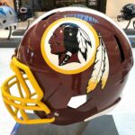Legal Twist Revives Banned Redskins Gear maroon football helmet with yellow facemask on display