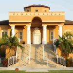 Sorority Nightmare: Strangulation Clue Emerges Fraternity house with columns and palm trees in front