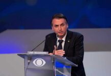 Knife-Edge Vote: Turnout Could Flip Brazil man in suit speaking at a podium