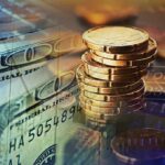 Stack of coins with US dollar bills and financial data overlay