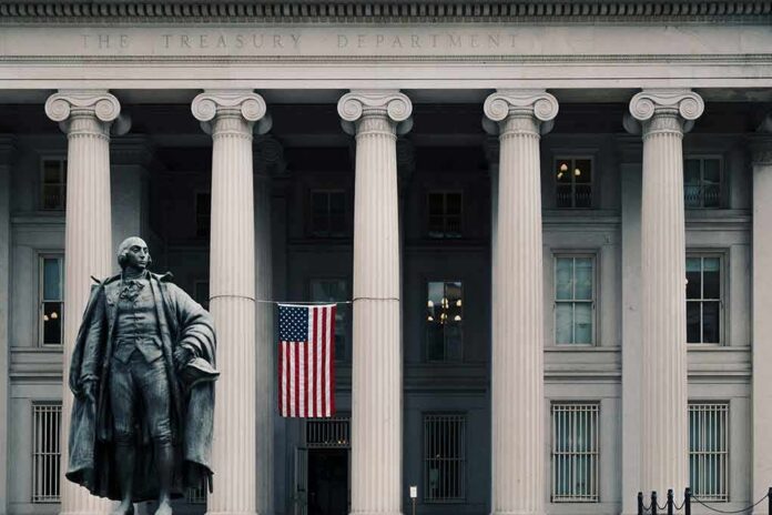 shutterstock_1240657660-1 Statue in front of a neoclassical government building with columns and a U.S. flag