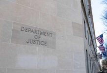 Elite Donor Home Searched – Warrant SEALED Department of Justice building exterior with American flags