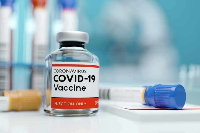 COVID-19 vaccine vial with test tube on lab bench