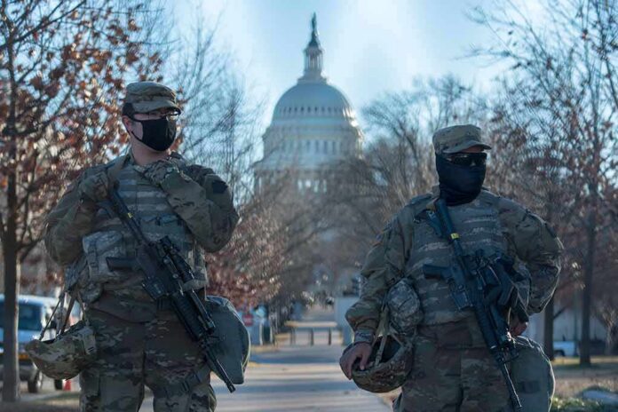 shutterstock_1898072065 Two armed soldiers stand guard near a domed government building