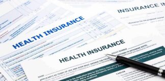 Close-up of health insurance application forms with a pen