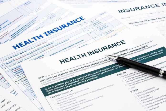 shutterstock_190551629 Close-up of health insurance application forms with a pen