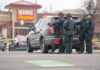 Soccer Field Chaos – Police Call Mass-Casualty Police officers gather beside a patrol SUV at a taped-off scene