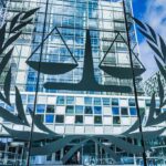 License Plate Tracking Gets Torched Scales of justice emblem on glass facade of modern office building