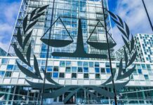 License Plate Tracking Gets Torched Scales of justice emblem on glass facade of modern office building