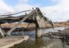 Collapsed concrete bridge over a river
