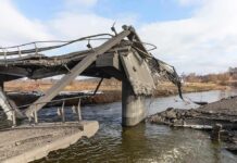 Collapsed concrete bridge over a river