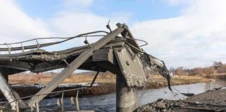 Collapsed concrete bridge over a river