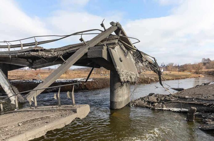 shutterstock_2134120967 Collapsed concrete bridge over a river