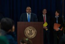 Acquitted Pastor Now Guilty – Same Facts Man at podium during press conference with officials behind him