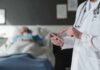 Dentist Visit Uncovers Deadly Time Bomb Doctor using tablet beside hospital patient