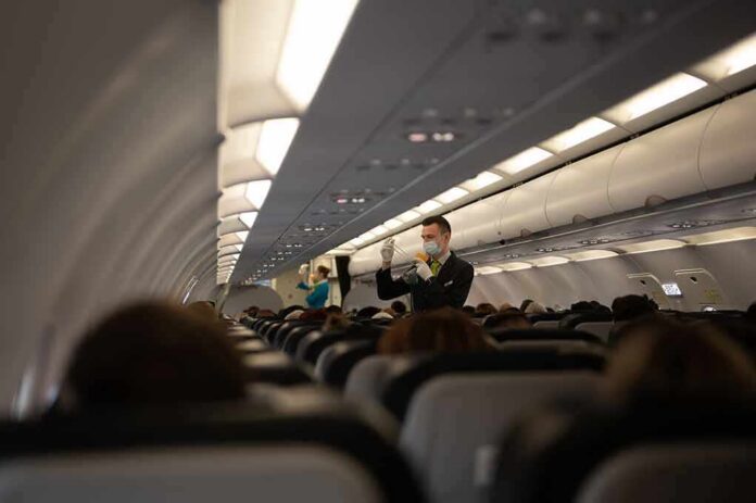 Flight attendant demonstrates safety procedures in airplane cabin