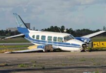 Low-Flying Ag Plane SLAMS School – No Kids Hurt Damaged blue and white small airplane on an airport runway