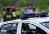 Elementary School Shooting Leaves 4 Dead Police car with blue light bar at roadside scene