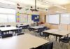 Bodycam Shock: Six-Year-Old Confesses Empty classroom with tables, chairs, and a whiteboard
