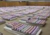 Gym Coach’s Double Life – Judge Drops Hammer rows of mattresses with striped bedding in a large hall