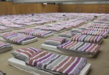 Gym Coach’s Double Life – Judge Drops Hammer rows of mattresses with striped bedding in a large hall